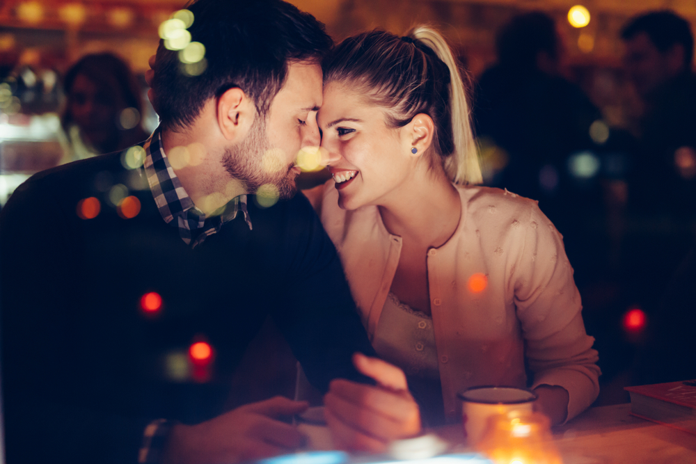 couple having fun on a date with a man asking woman questions on a speed date