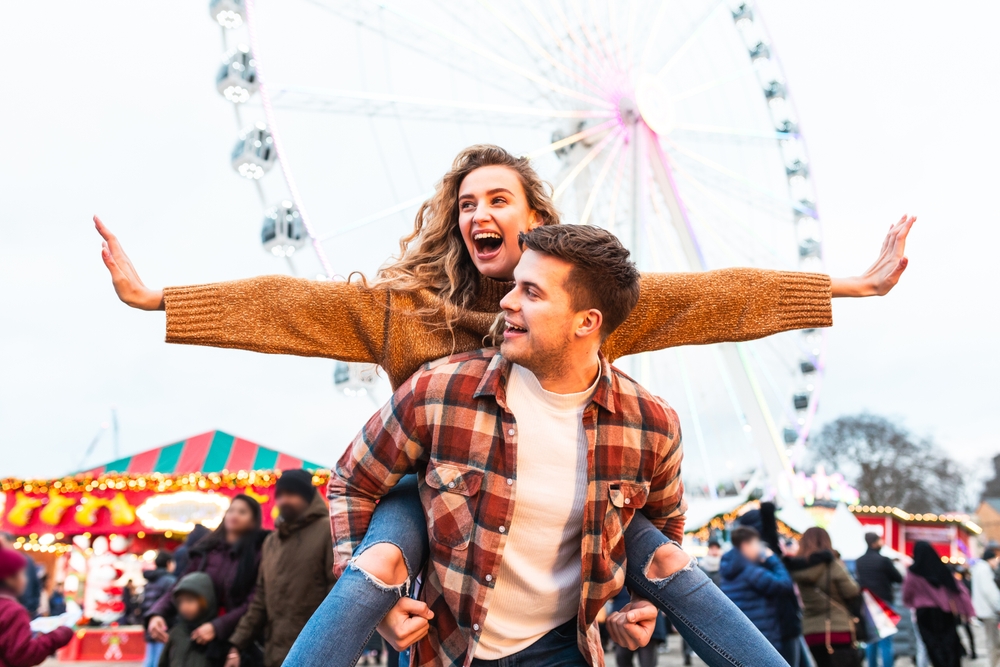 Happy,Couple,Having,Fun,At,Amusement,Park,In,London, after thinking of date ideas